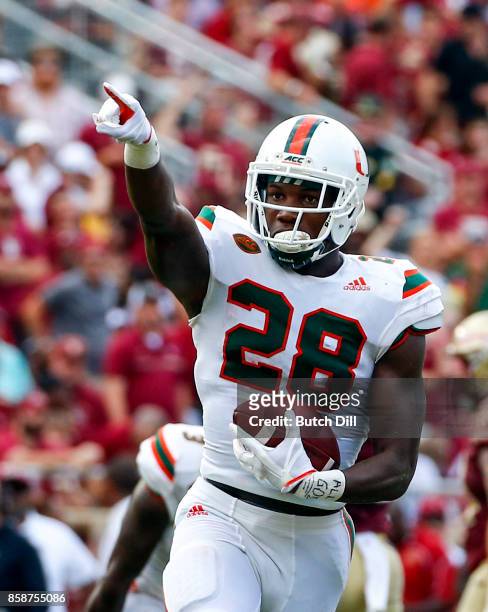 Defensive back Michael Jackson of the Miami Hurricanes celebrates after an interception against the Florida State Seminoles during the first half of...