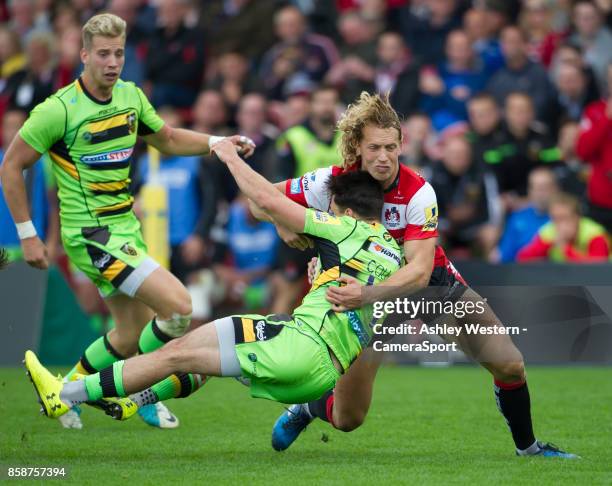 Northampton Saints' Tom Collins is tackled by Gloucester Rugby's Billy Twelvetrees during the Aviva Premiership match between Gloucester Rugby and...