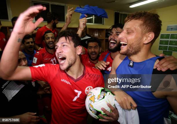 Tunisian soccer players celebrate after beating Guinea during the World Cup 2018 qualifying football match on October 7, 2017 at the Conakry Stadium....
