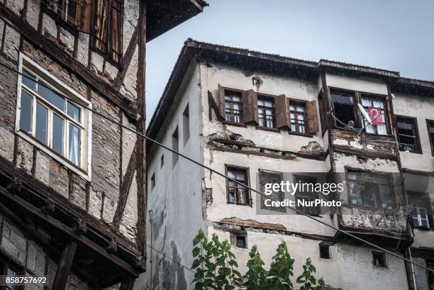 Woman peers out her window in the historic city of Safranbolu in Turkey's Black Sea region. The city became a UNESCO World Heritage site in 1994 due...