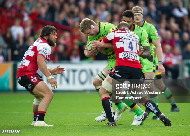 Northampton Saints' Jamie Gibson is tackled by Gloucester Rugby's Tom Savage during the Aviva Premiership match between Gloucester Rugby and...