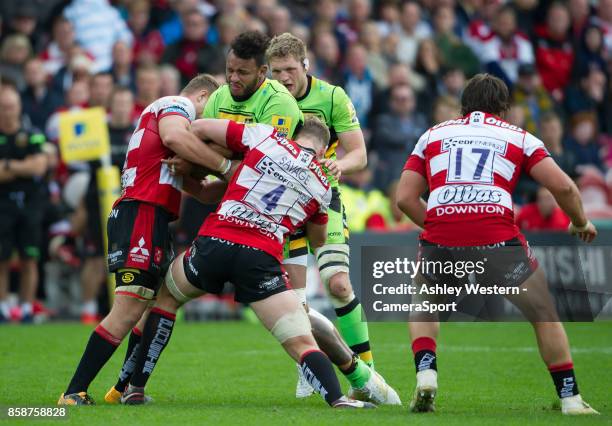 Northampton Saints' Courtney Lawes is tackled by Gloucester Rugby's Tom Savage during the Aviva Premiership match between Gloucester Rugby and...