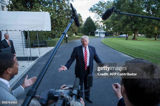 President Donald Trump speaks with reporters outside the White House prior to his departure aboard Marine One on October 7, 2017. During the...