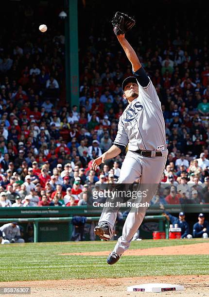 Matt Garza of the Tampa Bay Rays is unable to field a throw as he covers first against the Boston Red Sox at Fenway Park April 9 in Boston,...