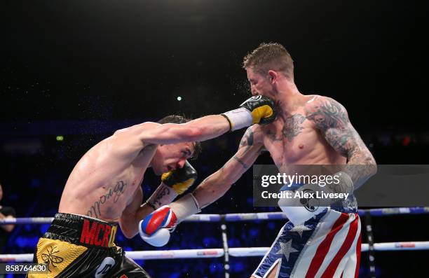Anthony Crolla and Ricky Burns exchange blows during the Lightweight contest at Manchester Arena on October 7, 2017 in Manchester, England.
