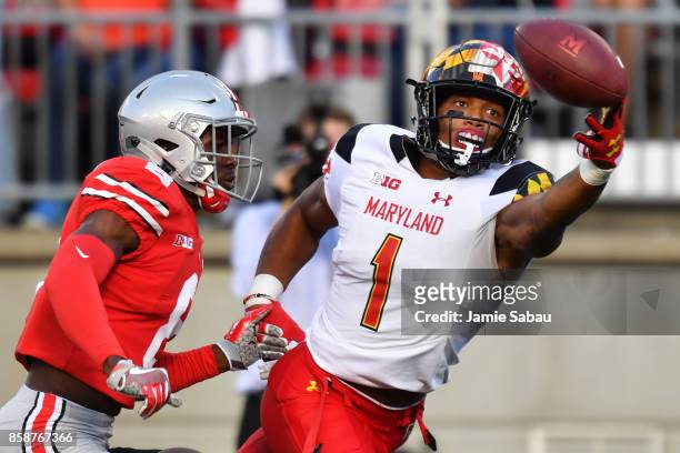 Moore of the Maryland Terrapins reaches but can't make the catch on a fourth down pass attempt in front of Kendall Sheffield of the Ohio State...