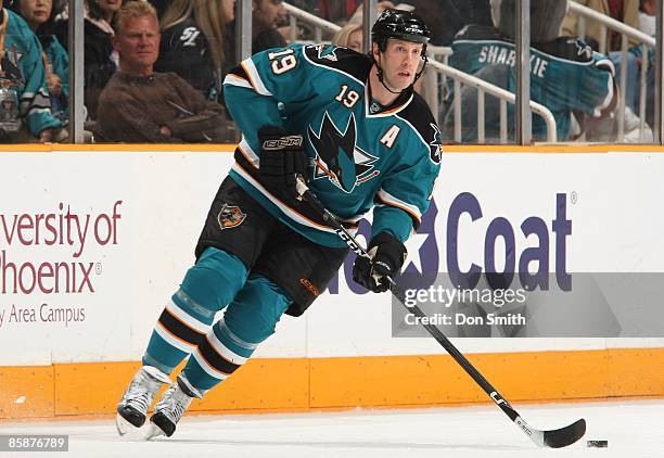 Joe Thornton of the San Jose Sharks skates down the ice with the puck, looking to pass, during an NHL game against the Colorado Avalanche on April 7,...