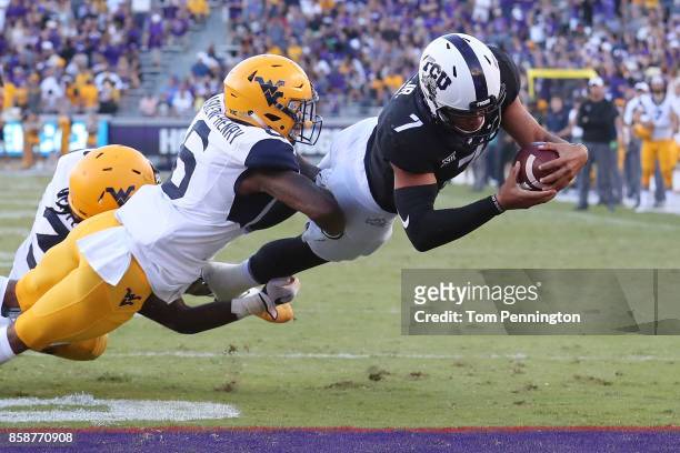 Kenny Hill of the TCU Horned Frogs dives into the end zone to score the game winning touchdown against Dravon Askew-Henry of the West Virginia...