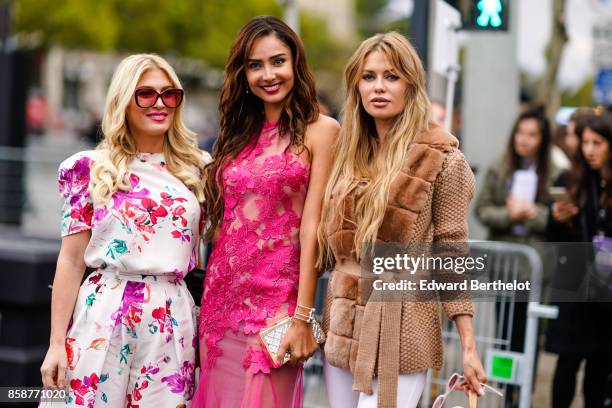 Hofit Golan wears a floral print dress and Patricia Contreras wears a pink dress, outside Le Defile L'Oreal Paris as part of Paris Fashion Week...