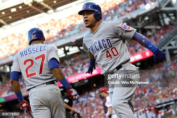 Willson Contreras of the Chicago Cubs celebrates with Addison Russell of the Chicago Cubs after hitting a solo home run against the Washington...