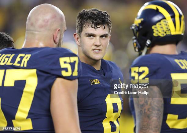 John O'Korn of the Michigan Wolverines talks with his teammates prior to the start of the game against the Michigan State Spartans at Michigan...