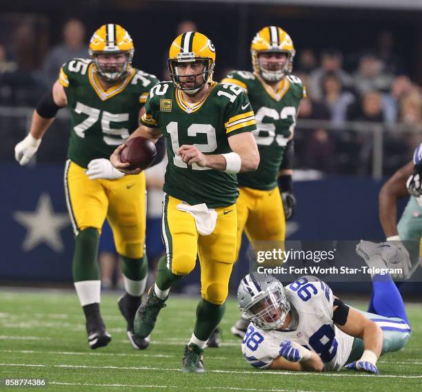 Green Bay Packers quarterback Aaron Rodgers scrambles against the Dallas Cowboys in the NFL Divisional Playoff game on January 15 at AT&T Stadium in...