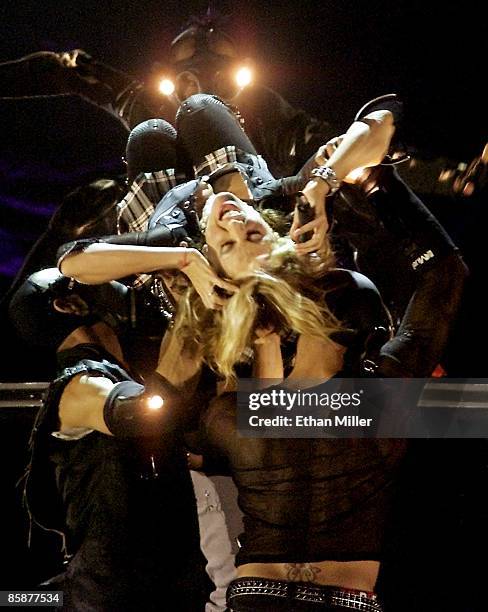 Madonna is carried by dancers as she performs during the first of two sold-out shows at the MGM Grand Garden Arena during her Drowned World Tour...