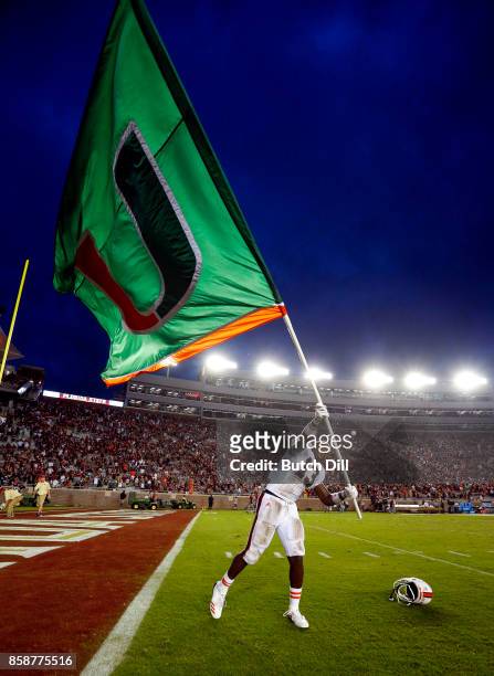 DeeJay Dallas of the Miami Hurricanes waves the flag after they defeated the Florida State Seminoles 24-20 during the second half of an NCAA football...