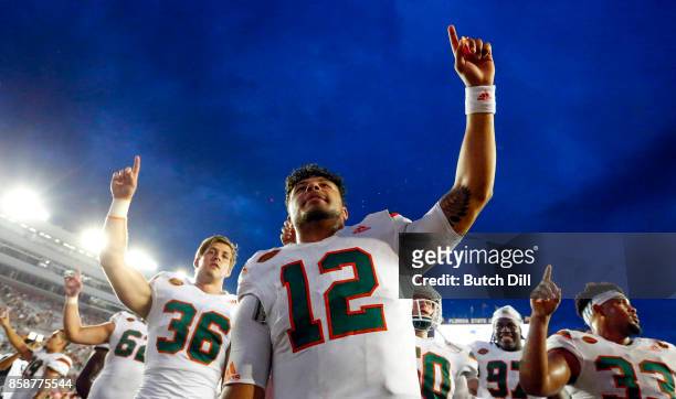 Quarterback Malik Rosier of the Miami Hurricanes celebrates with teammates after they defeated the Florida State Seminoles 24-20 during the second...
