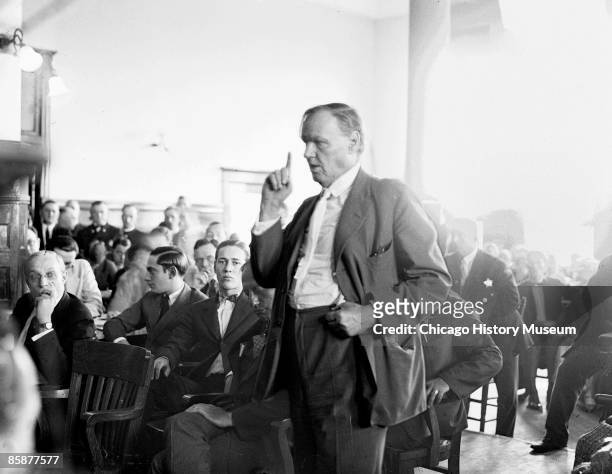 During the 'Trial of the Century', defense attorney Clarence Darrow, points a finger up while arguing for the defense in the center of a crowded...