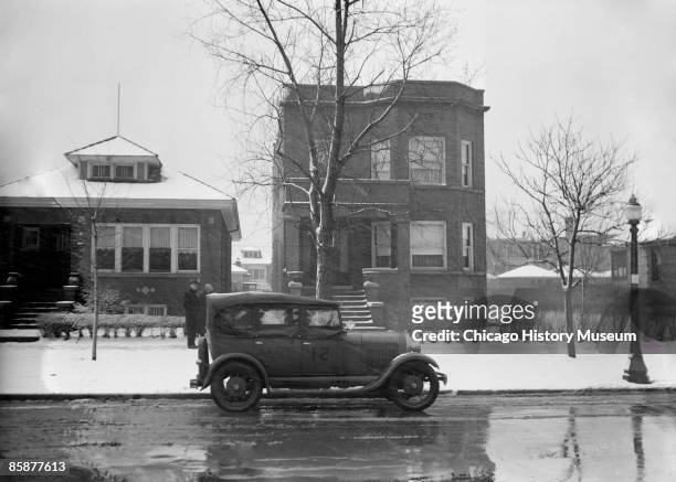 Police car sits outside Al Capone's house, located at 7244 Prairie Avenue in Chicago, ca.1920s.