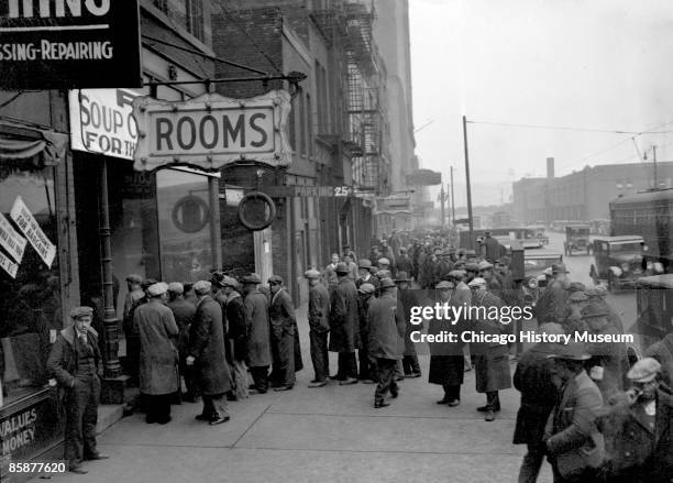 Group of men line up outside a Chicago soup kitchen opened by Al Capone, ca.1930s. In a bid to rebuild his reputation, Capone opened a soup kitchen...