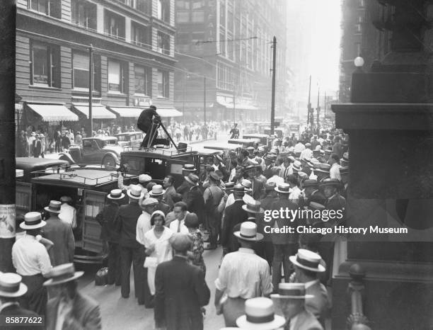 Huge crowds gather outside the Federal Building in Chicago to get a glimpse of notorious gangster Al Capone during his trial for tax evasion, 1931.