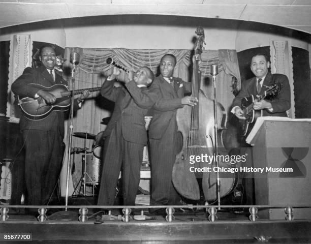 An unidentified band plays some jazz onstage at an unidentified venue in Chicago, ca.1920s. African-American musicians from New Orleans and the...