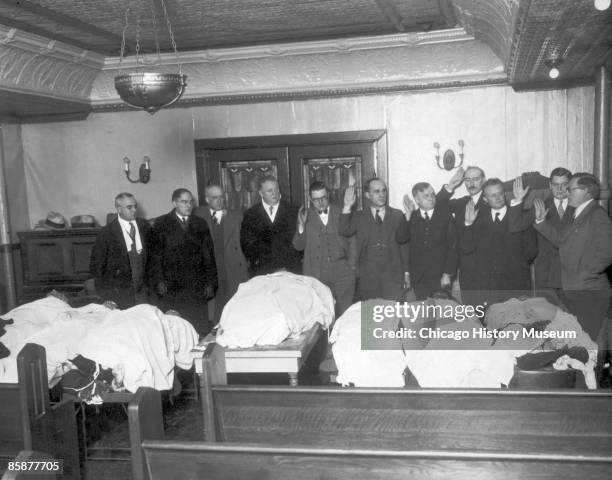 Special crime committee is sworn in over the bodies of the victims of the St. Valentine's Day Massacre, Chicago, 1929. The killings spurred the...