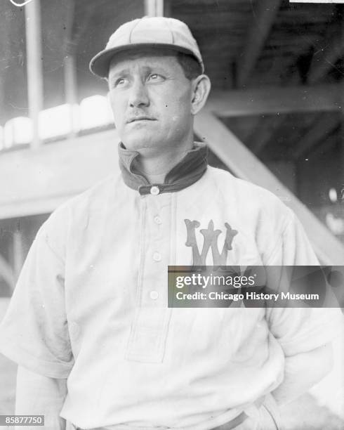 Half-length portrait of Ed Delahanty, an outfielder for the Washington Senators, American League baseball team standing in front of bleacher...