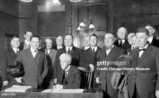 Judge Kenesaw Mountain Landis, commissioner of baseball from 1920 to 1944, sits in a Chicago courtroom surrounded by : Connie Mack , Phil Ball ,...