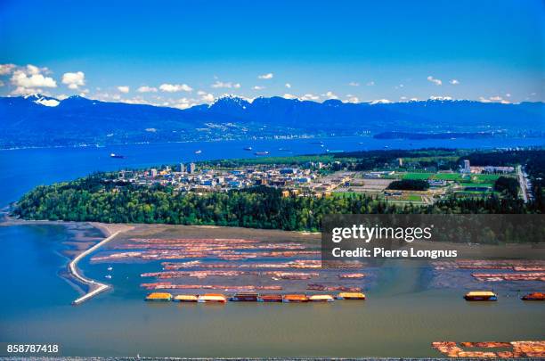 aerial view on the fraser delta and timber raft with the university of british columbia and the coast mountain range in the background - vancouver, british columbia, canada - university of british columbia stock pictures, royalty-free photos & images