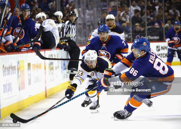 Victor Antipin of the Buffalo Sabres and Nikolay Kulemin of the New York Islanders battle for the puck during the second period at the Barclays...