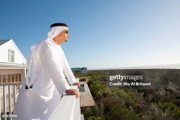 arab man standing in balcony. - arab villa stockfoto's en -beelden