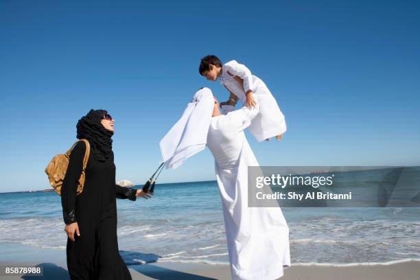 arab family on beach. - dubai cares stock pictures, royalty-free photos & images
