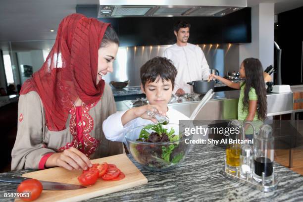 arab family cooking in kitchen. - jalabib stock pictures, royalty-free photos & images