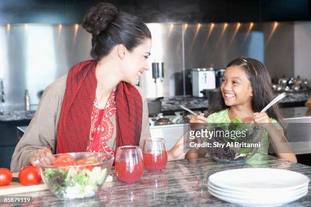 mother with daughter cooking in kitchen. - jalabib imagens e fotografias de stock