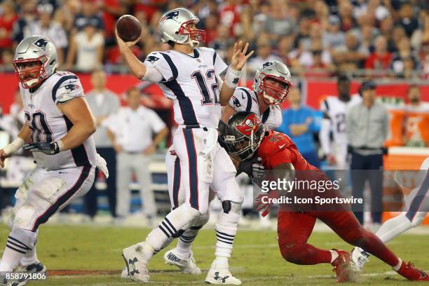 Tom Brady of the Patriots is rushed by Buccaneers defensive lineman Robert Ayers Jr. During the NFL Regular game between the New England Patriots and...