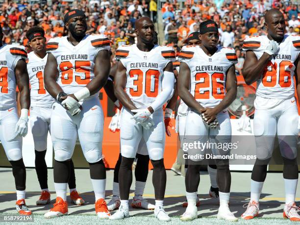 Defensive lineman Larry Ogunjobi, cornerback Jason McCourty, safety Derrick Kindred and tight end Randall Telfer of the Cleveland Browns stand on the...