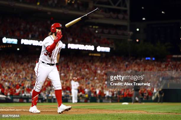 Bryce Harper of the Washington Nationals flips his bat after hitting an eighth inning two-run home run during Game 2 of the National League Division...