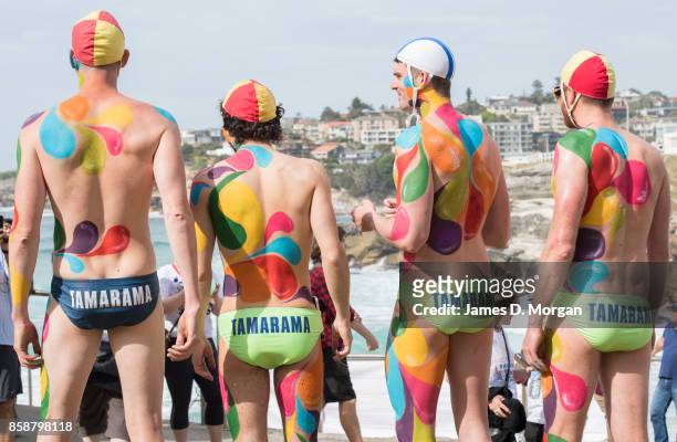 Lifesavers from the Tamarama surf lifesaving club with body paint take part in the Rainbow Walk between Bondi Beach and Bronte Beach on October 8,...