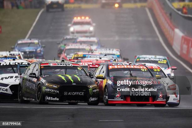 Shane Van Gisbergen drives the Red Bull Holden Racing Team Holden Commodore VF and Cameron Waters drives the Monster Energy Ford Falcon FGX battle...