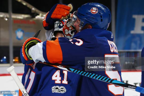 Casey Cizikas of the New York Islanders celebrates defeating the Buffalo Sabres with Jaroslav Halak at Barclays Center on October 7, 2017 in New York...