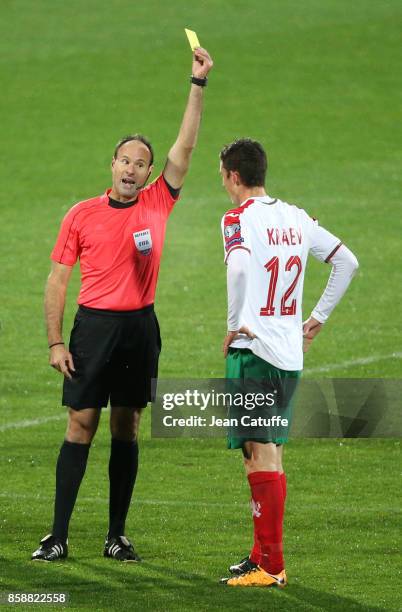 Referee Antonio Mateu Lahoz of Spain gives a yellow card to Bozhidar Kraev of Bulgaria during the FIFA 2018 World Cup Qualifier between Bulgaria and...