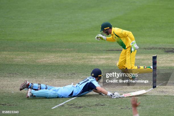 Harry Nielsen of CAXI runs out Ed Cowan of NSW during the JLT One Day Cup match between New South Wales and the Cricket Australia XI at Hurstville...