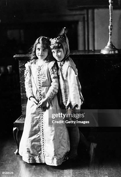 The future Queen Elizabeth, Lady Elizabeth Bowes-Lyon, left, wears a fancy-dress costume, circa 1909, with her brother, Lord David Bowes-Lyon at...