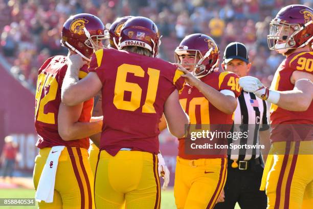 Jake Olson, who is blind, is mobbed by his teammates after snapping the ball during a college football game between the Oregon State Beavers and the...