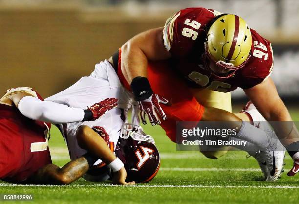 Josh Jackson of the Virginia Tech Hokies is tackled by Harold Landry and Ray Smith of the Boston College Eagles during the second quarter of their...