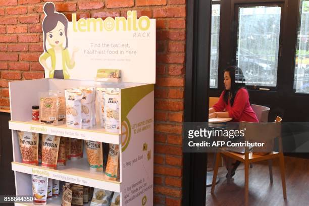 This picture taken on September 12, 2017 shows a woman working at the EV-Hive event space, a co-working space, in Jakarta. Big-name investors...