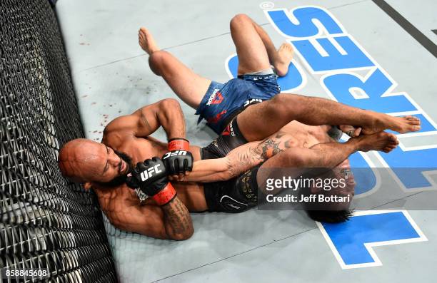Demetrious Johnson secures an arm bar submission against Ray Borg in their UFC flyweight championship bout during the UFC 216 event inside T-Mobile...