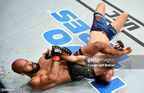 Demetrious Johnson secures an arm bar submission against Ray Borg in their UFC flyweight championship bout during the UFC 216 event inside T-Mobile...