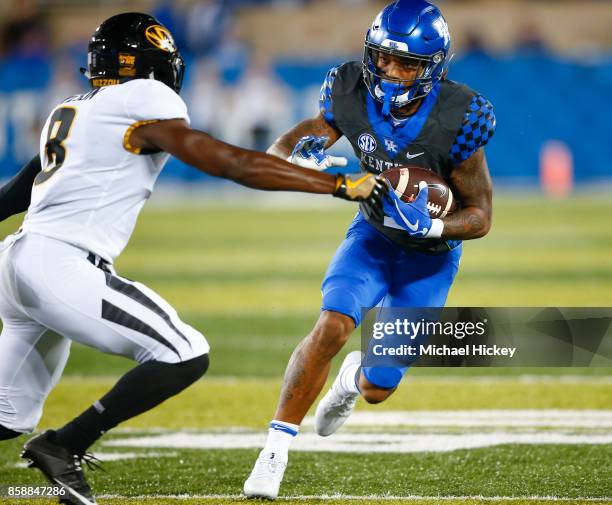 Lynn Bowden Jr. #1 of the Kentucky Wildcats runs the ball as Thomas Wilson of the Missouri Tigers looks to make the tackle at Commonwealth Stadium on...