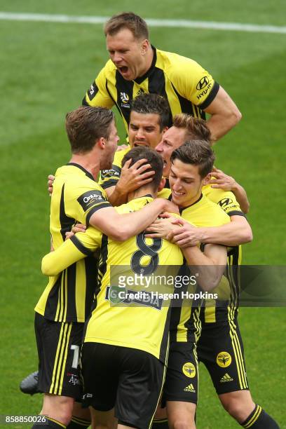 Dario Vidosic of the Phoenix celebrates with teammates after scoring a goal during the round one A-League match between Wellington Phoenix and...