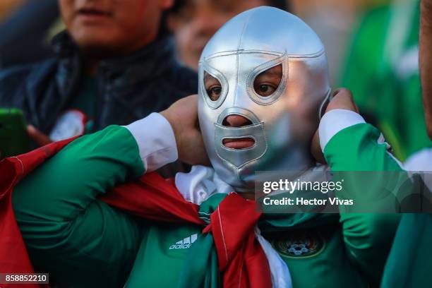 Fan of Mexico puts on a wrestling mask prior the match between Mexico and Trinidad & Tobago as part of the FIFA 2018 World Cup Qualifiers at Alfonso...